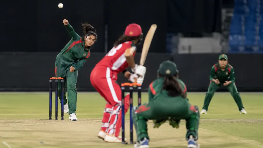 A Bangladesh bowler delivering the ball during a match, with fielders positioned around the pitch