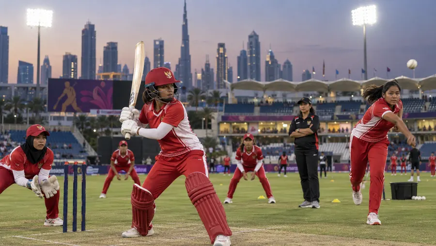 Indonesia's team practising in the nets before the tournament, with the Dubai skyline behind them